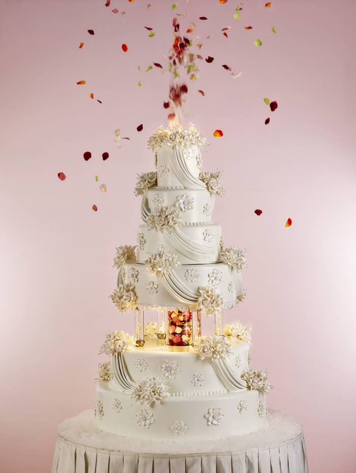 A huge wedding cake with flower petal confetti
