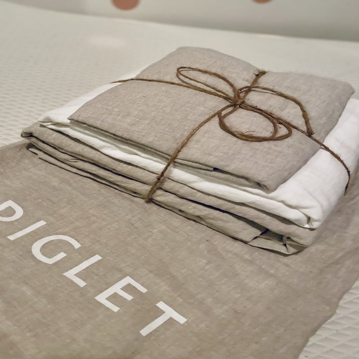 the linen bedsheet folded in a stack 
