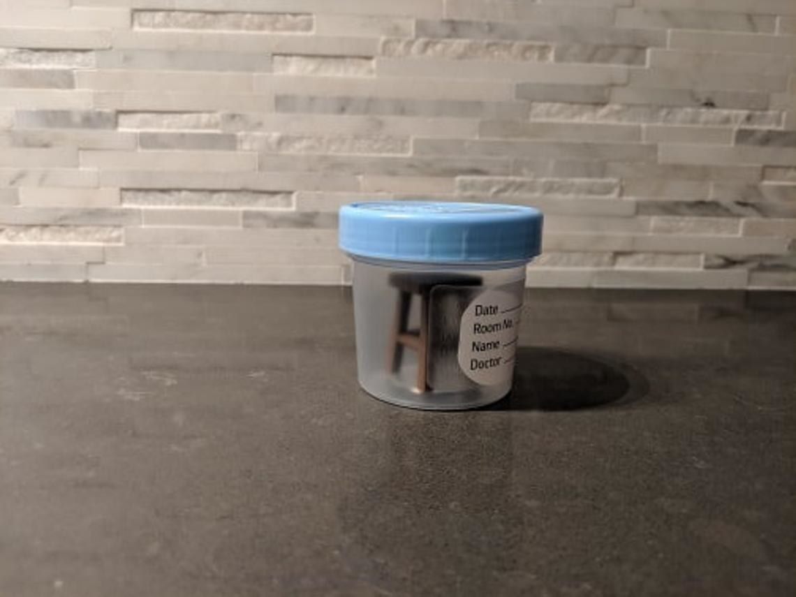 small stool in medical container