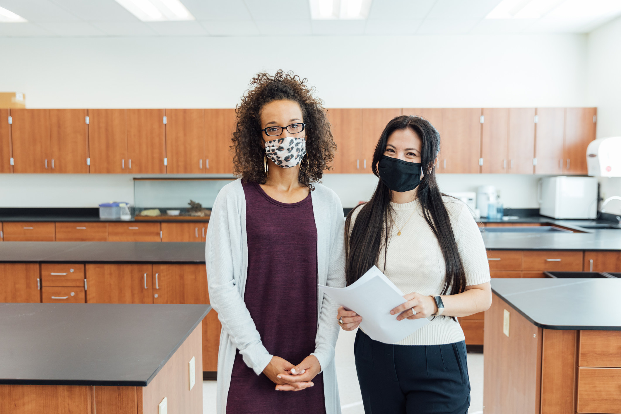 Two teachers wearing masks in a science classroom