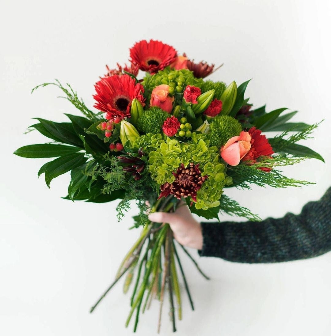 person holding bouquet of flowers