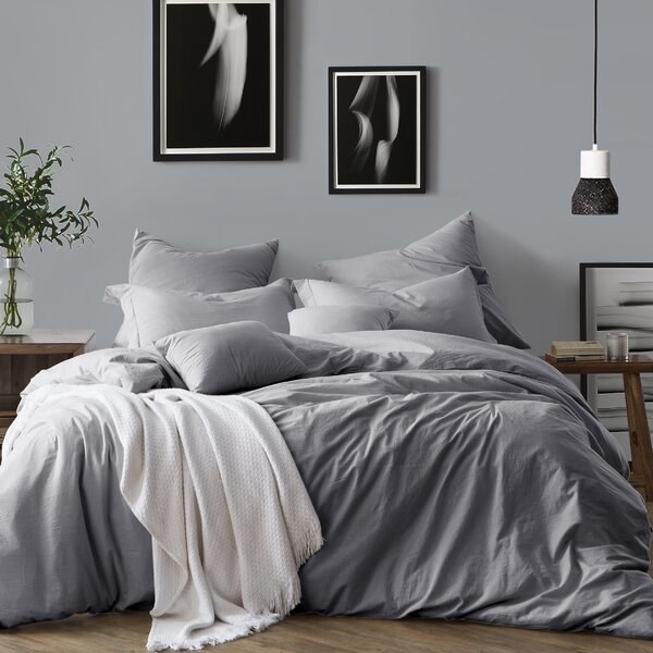 bed with grey duvet cover and pillows