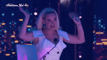 Katy cheers for a contestant from the judges table
