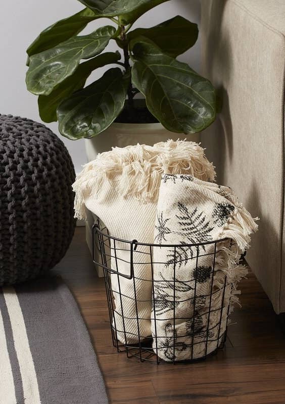Metal basket with throw blankets inside