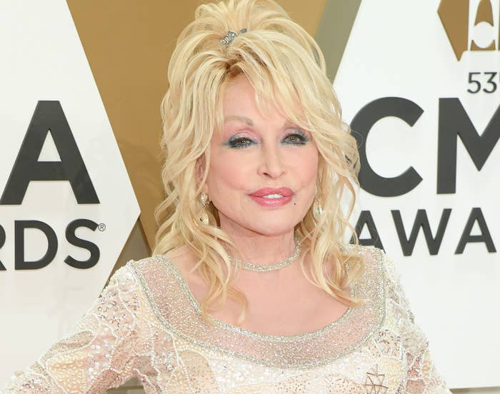 Dolly smiles in a shimmering gown on a red carpet