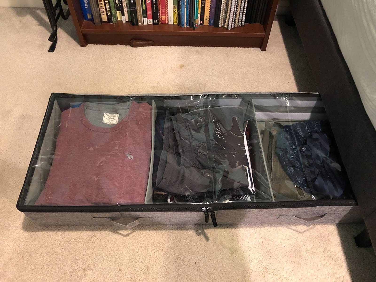 reviewer image of clothes packed into three compartments of the under bed storage containers