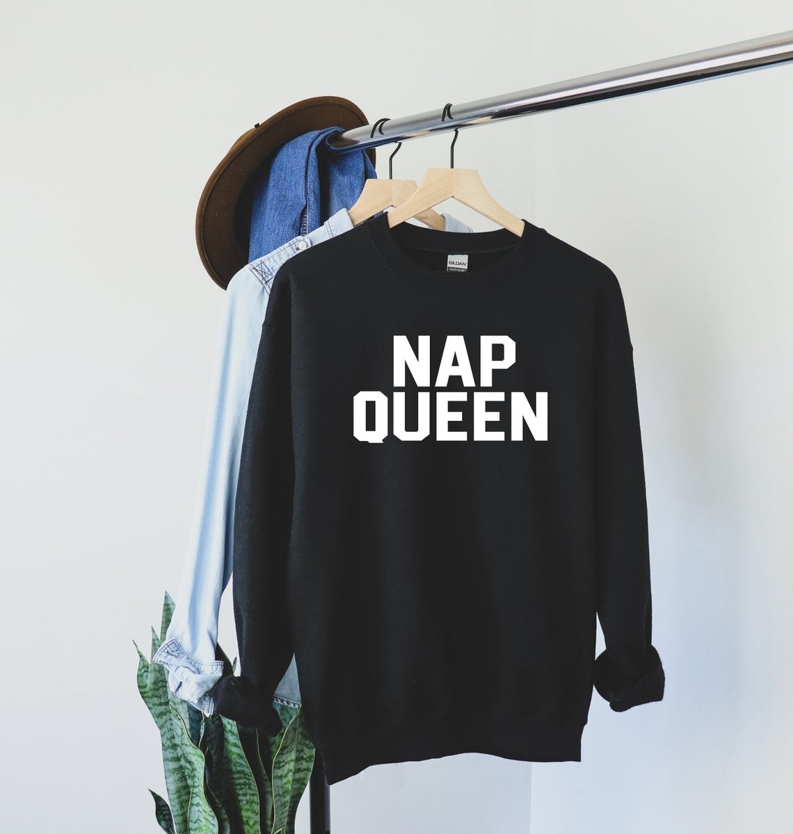 An oversized sweatshirt with a text graphic saying nap queen