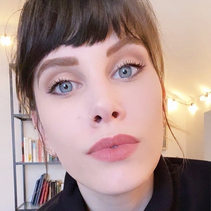 Reviewer wearing taupe-pink lipstick