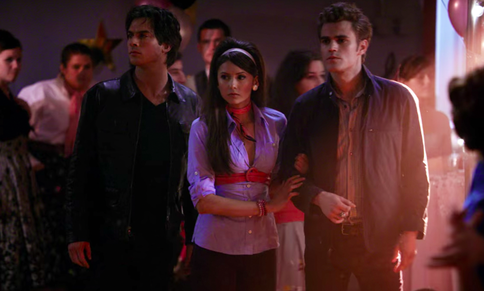 Damon, Elena, and Stefan walking into a school dance together 