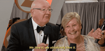 a gif of two people at an award show and one saying &quot;we love it, we absolutely love it&quot; 