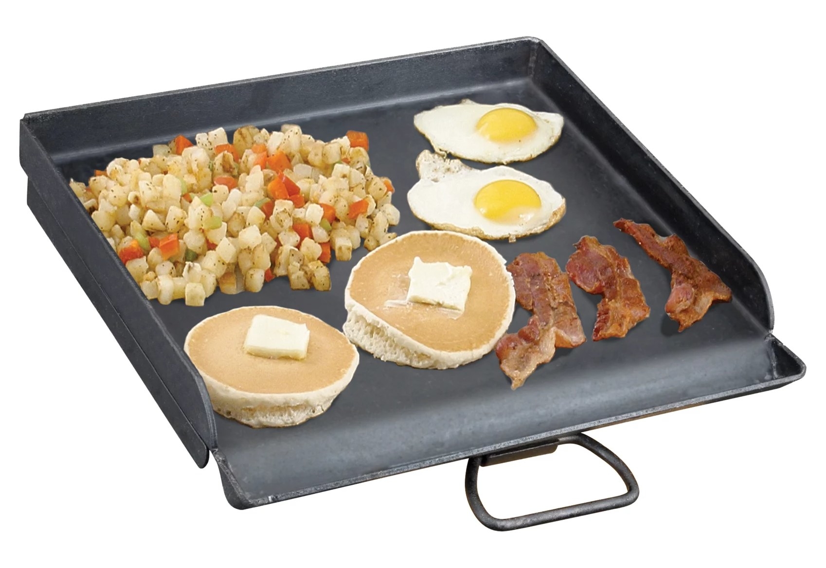 The griddle with pancakes, bacon, eggs, and potatoes