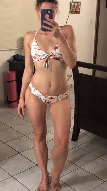 The same reviewer in the white floral side of the swimsuit