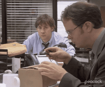 Gif of Dwight from The Office opening a box