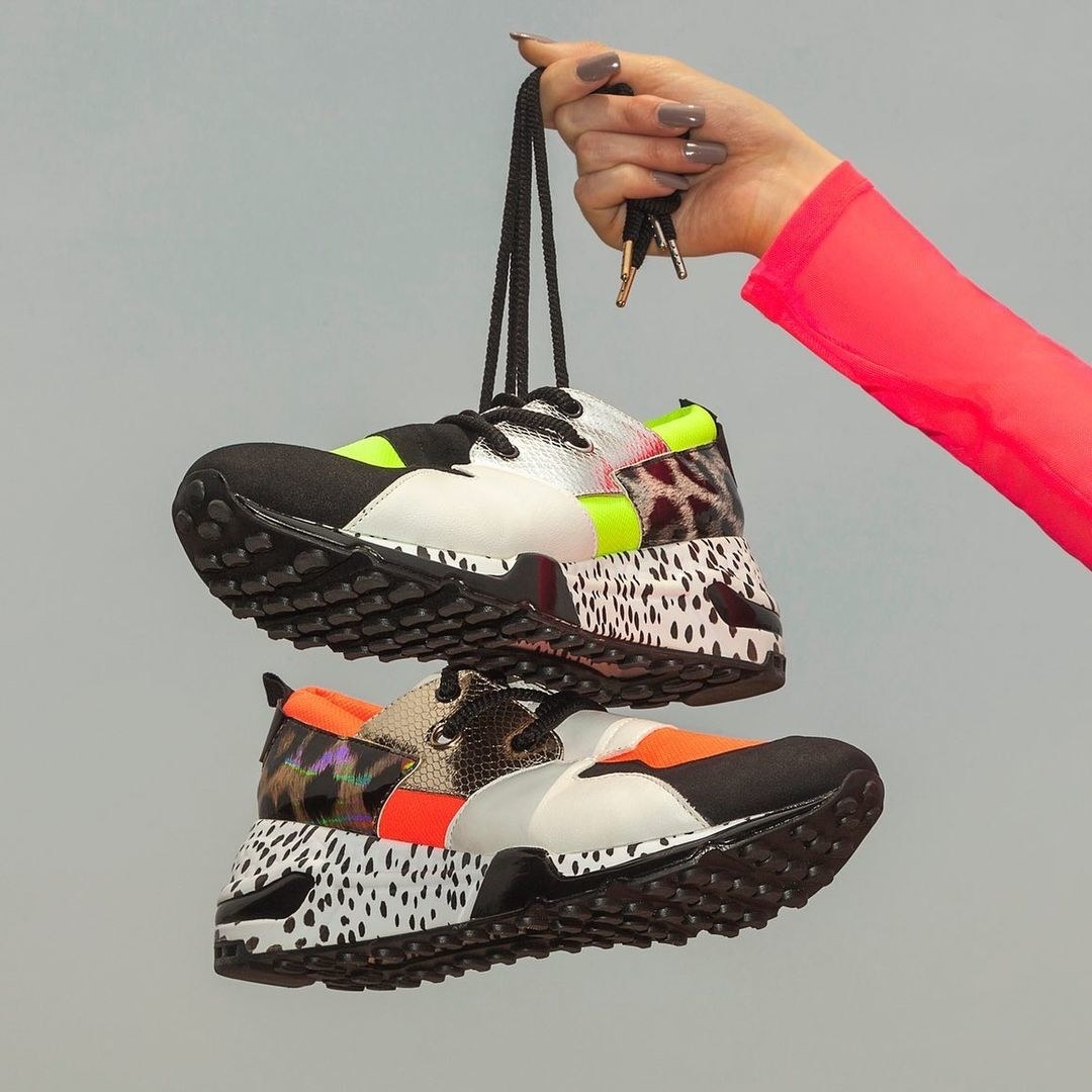 a model holding the sneaker in two different prints