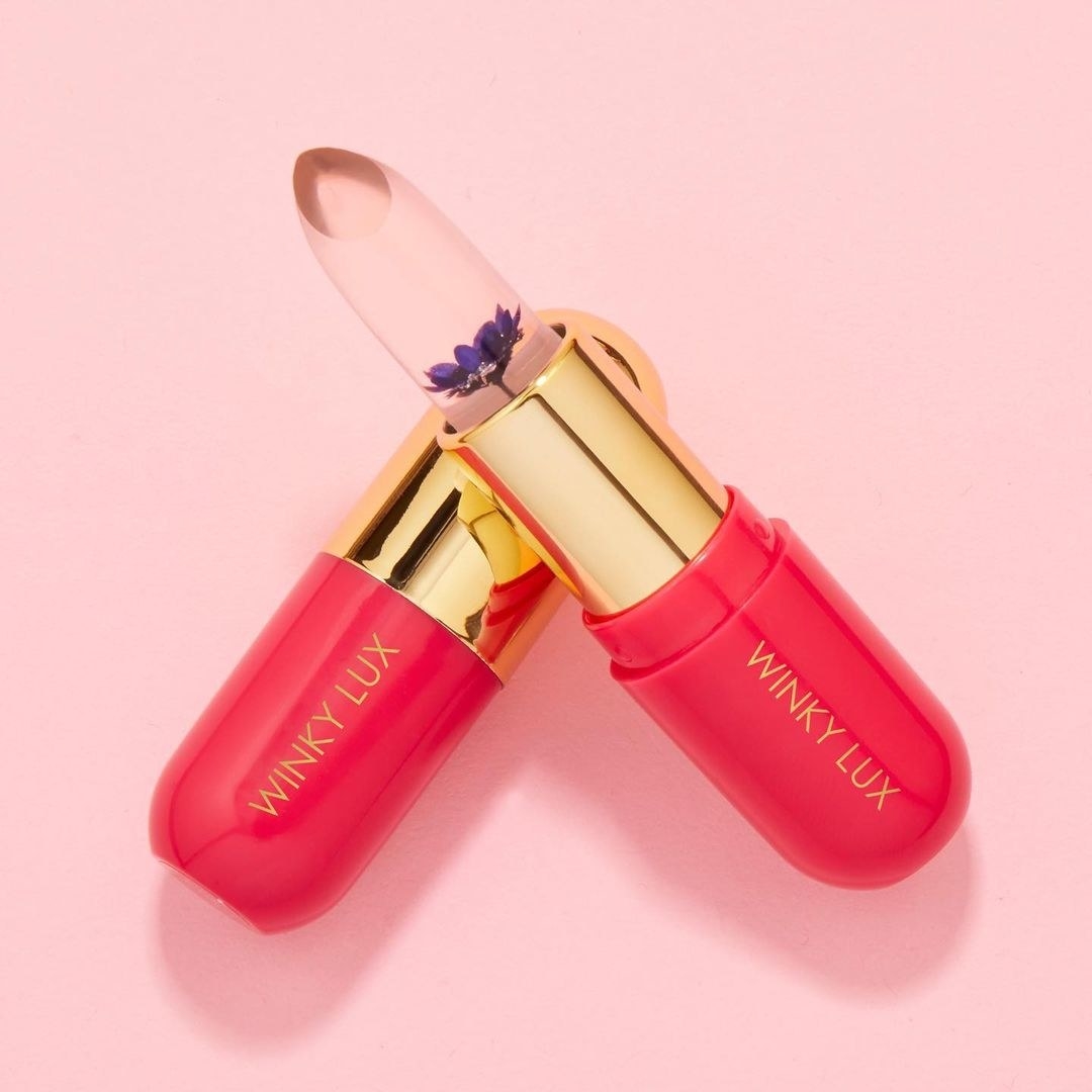 Winky Lux lip balm against pink background