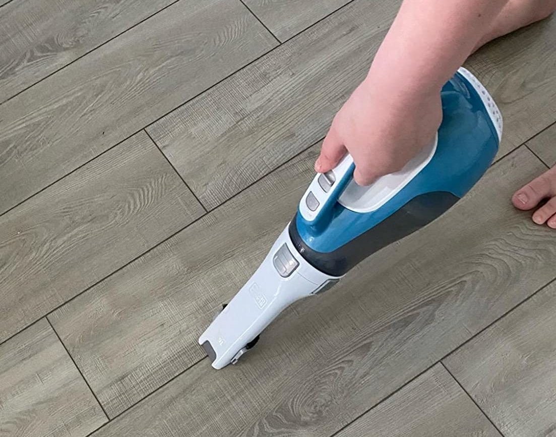 Reviewer using product to clean crumbs off floor