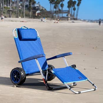 the lounge chair folded out sitting on a beach 
