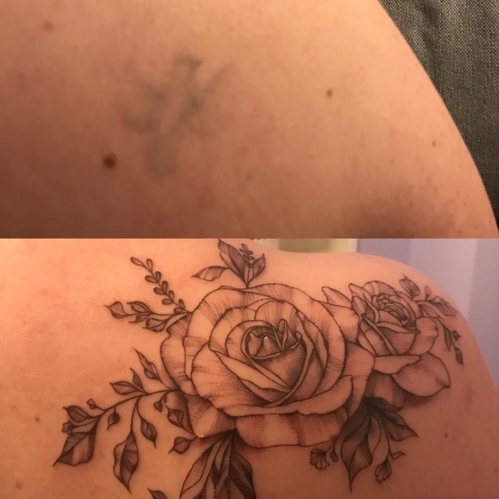 An extremely faded tattoo of a bird and a detailed cover-up of flowers