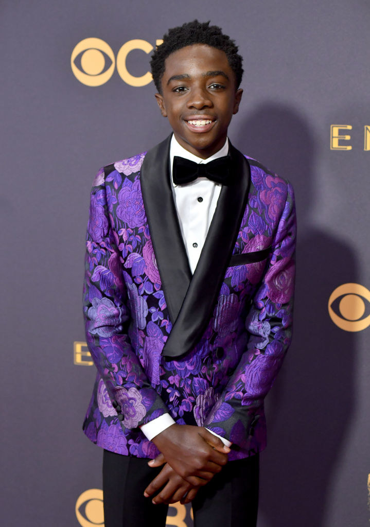 Caleb is wearing a floral printed tuxedo jacket at an awards show. 