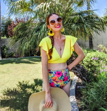 A customer review photo them wearing the two-piece in floral yellow