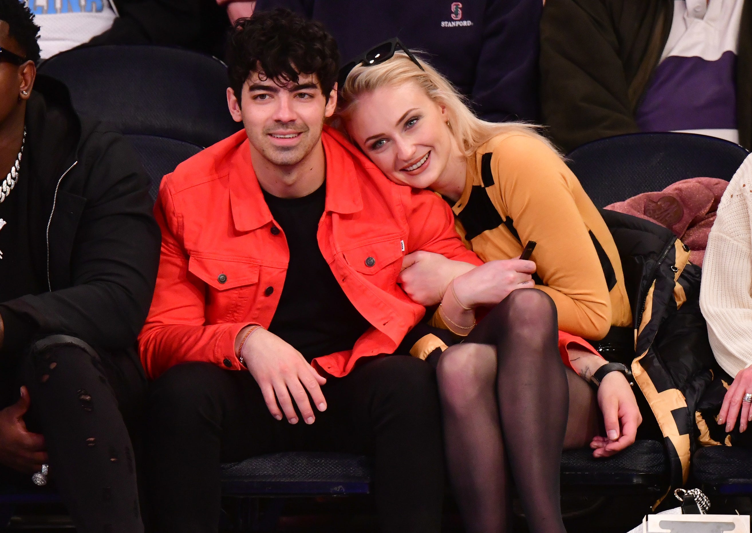 Sophie cuddles up to Joe while sitting at an event