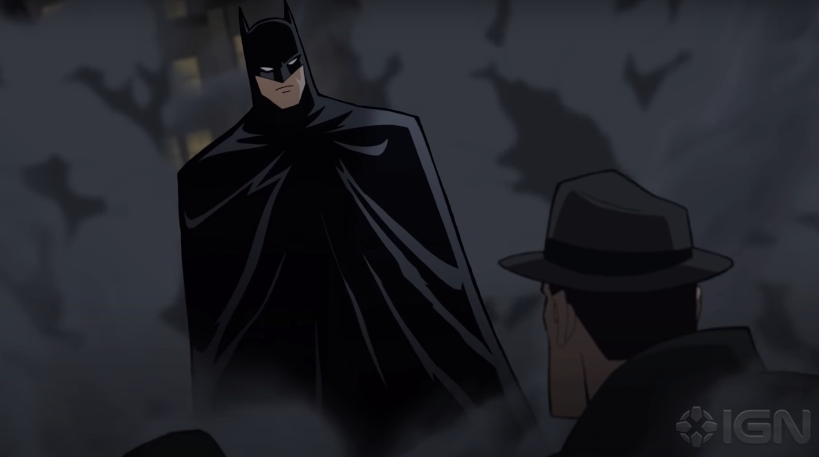 Batman stands in a cloud of dust in the movie