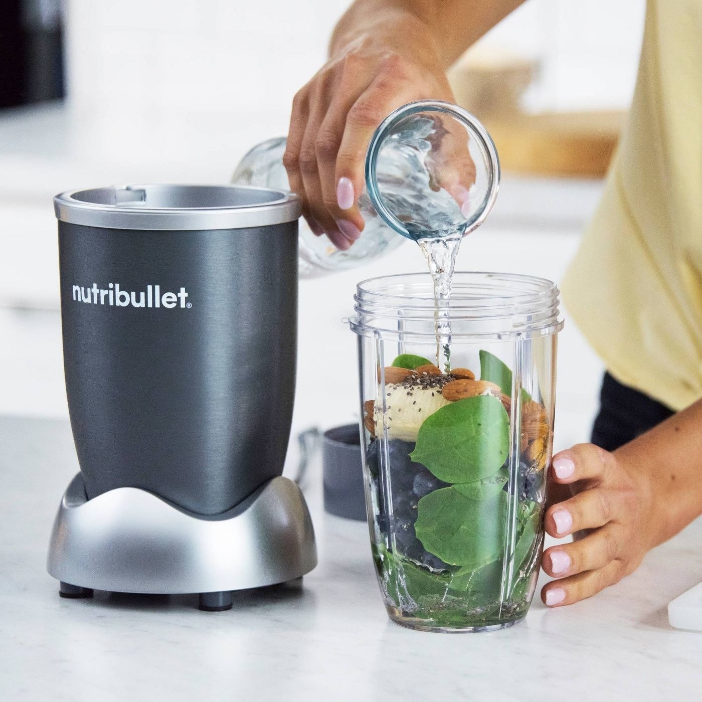 A model making a smoothing with a NutriBullet blender