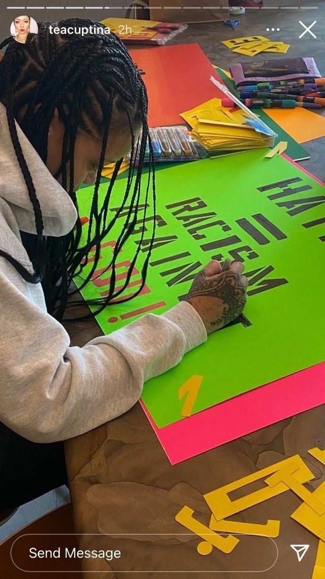Rihanna creates the sign on a large poster board 