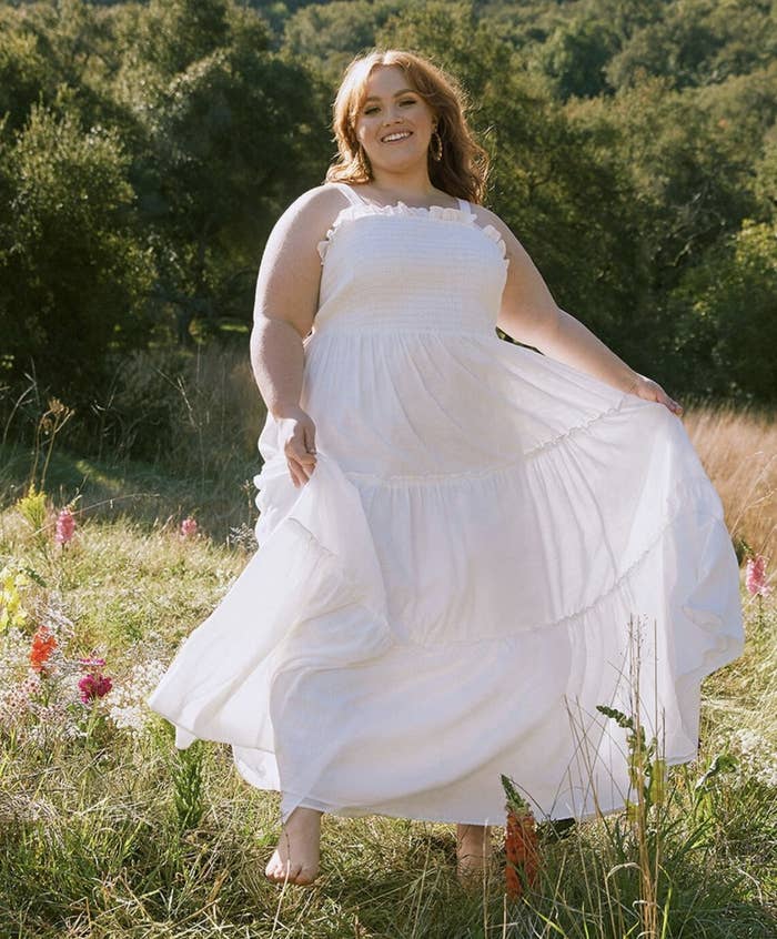 a model wearing the dress in white