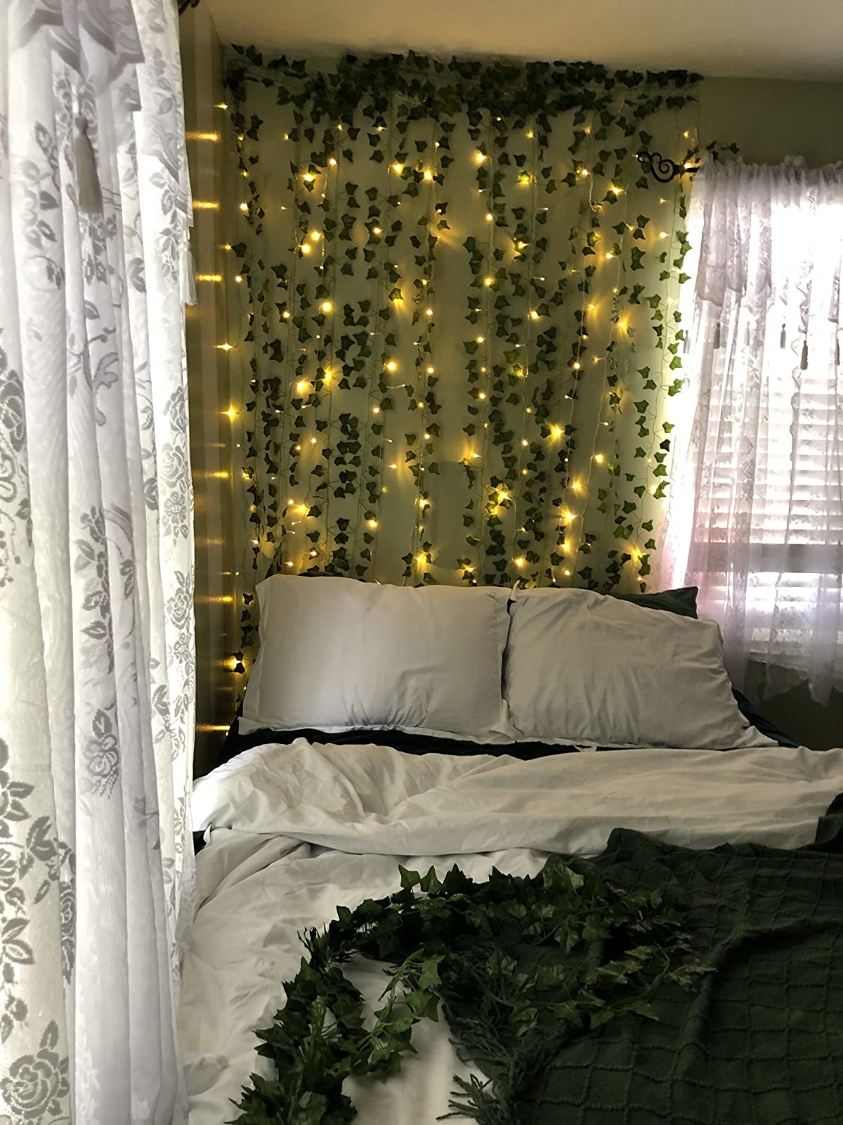 reviewer showing the lights and ivy above their bed