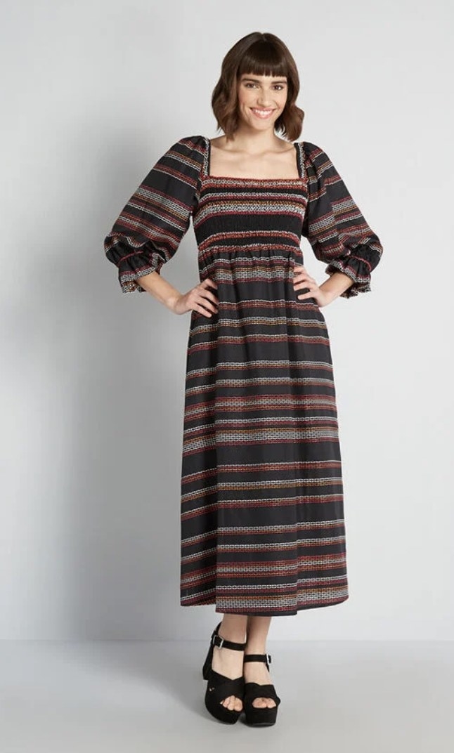 a model wearing the dress with black sandals