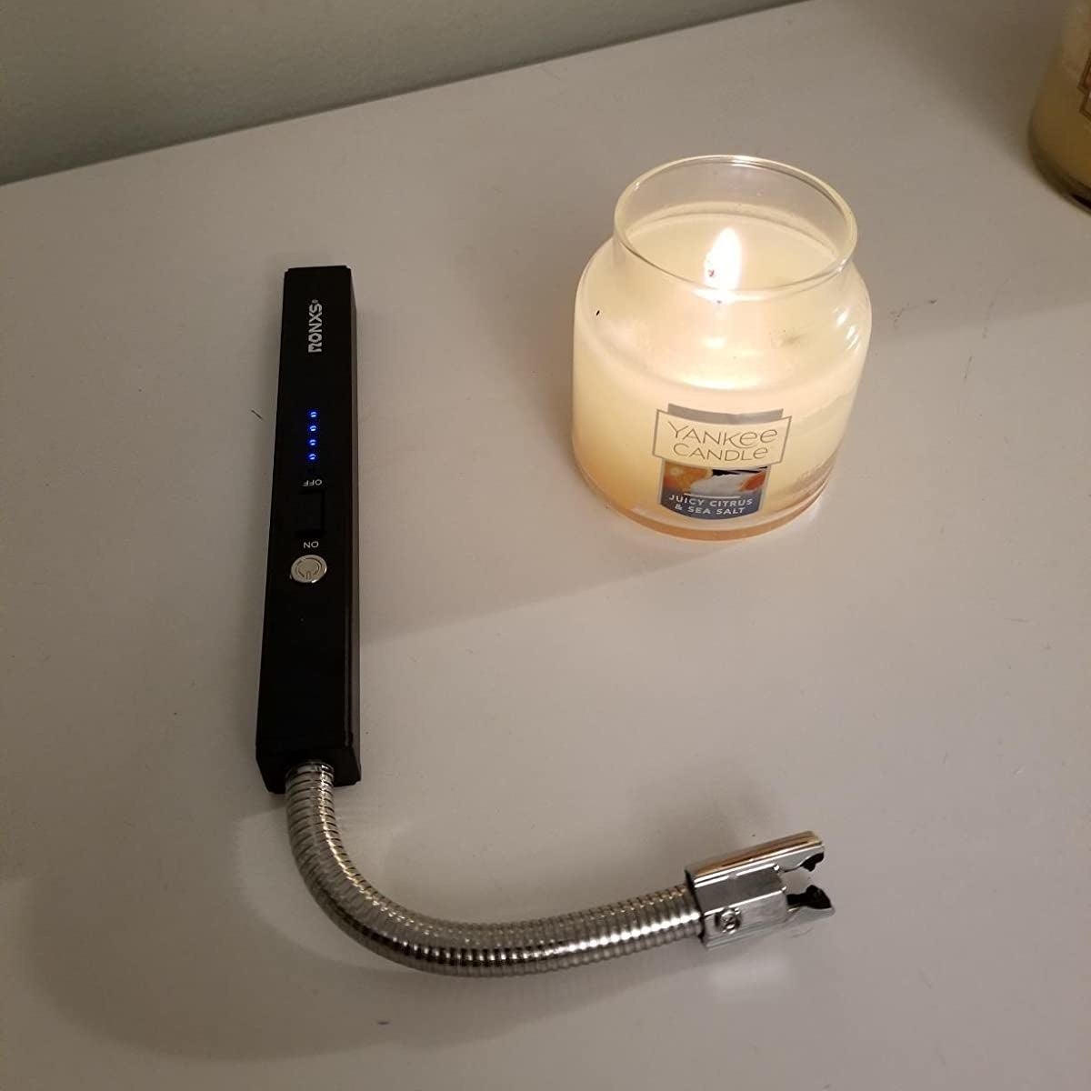 reviewer photo showing the lighter next to a candle 