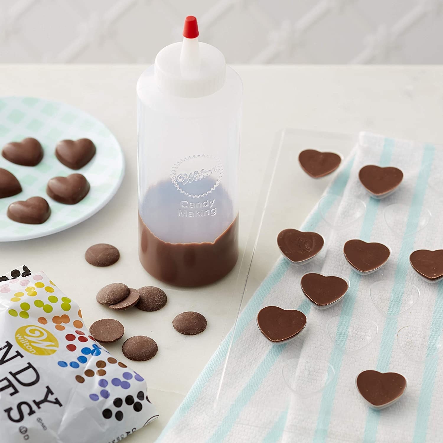 The squeeze bottle surrounded by chocolates