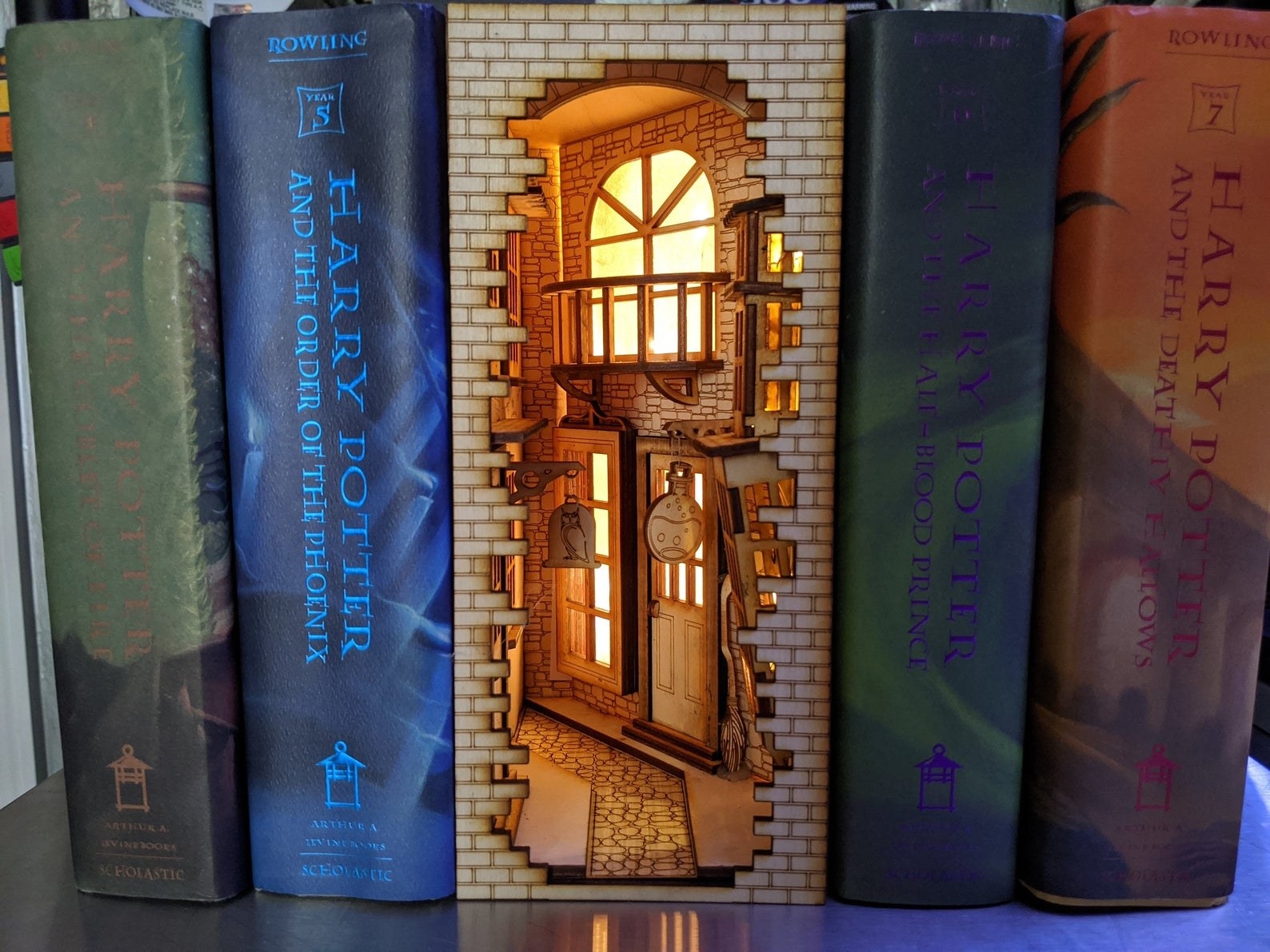 the lit-up book nook in between harry potter books
