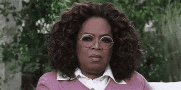 Oprah shaking her head in disdain.