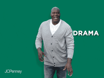 GIF of Shaq smiling widely and whacking off various text blocks reading, &quot;Bad Vibes,&quot; &quot;Negativity,&quot; &quot;Drama,&quot; and &quot;Anxiety.&quot; He is standing against a solid green background.