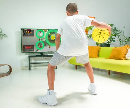 Model uses the basketball and a smart TV to do a training session