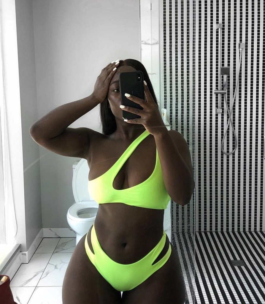 model in neon green bikini with cut outs on the hips and shoulder