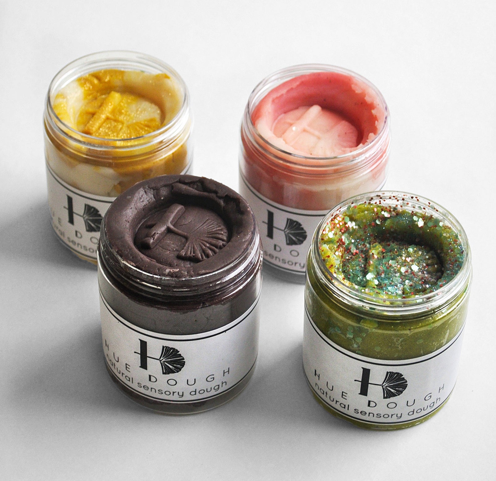 A set of four jars of sensory dough, each in a different colour