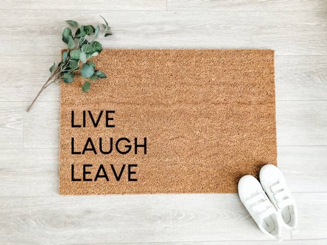 a door mat with the words live laugh leave