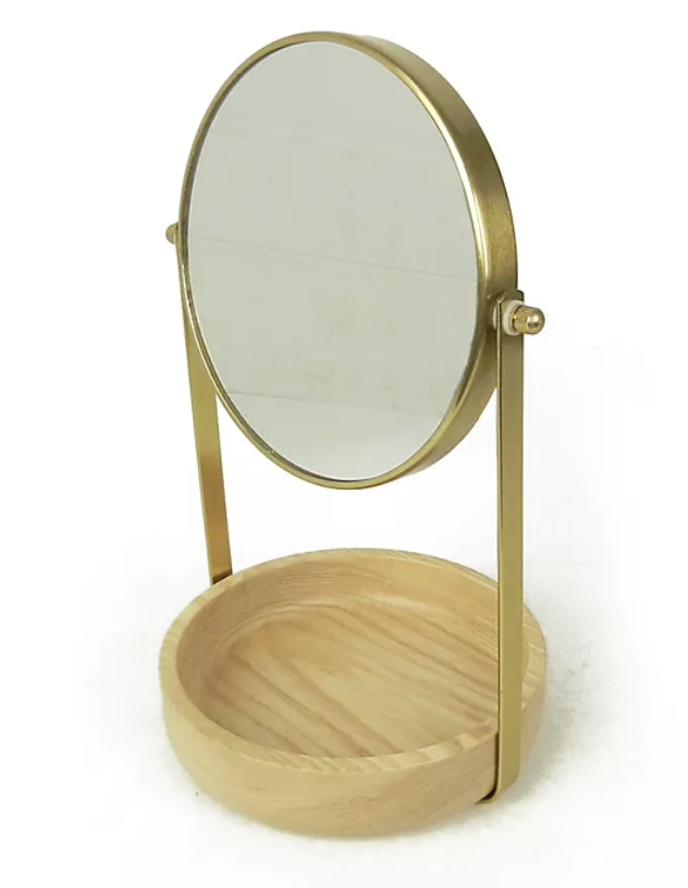 The gold vanity mirror with a wooden base