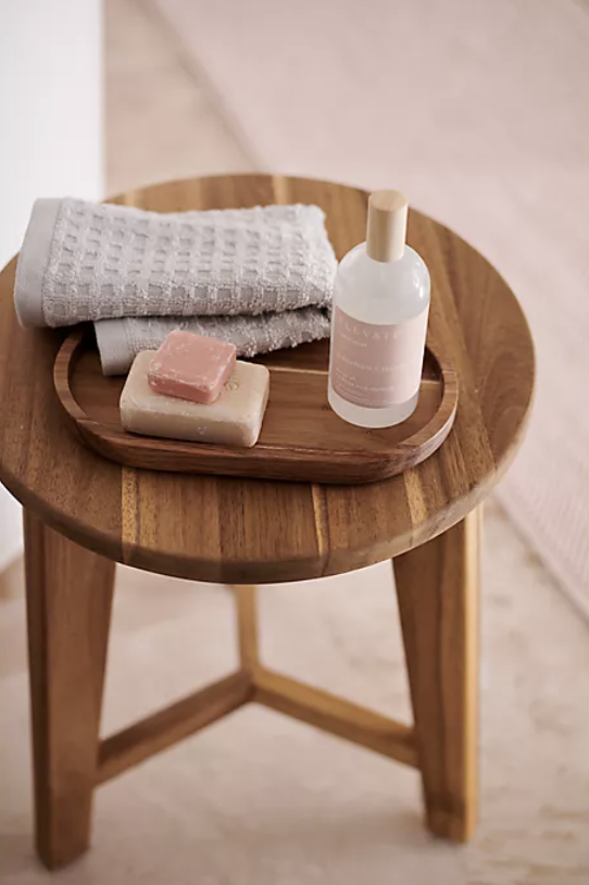 A close-up of the wooden bath stool