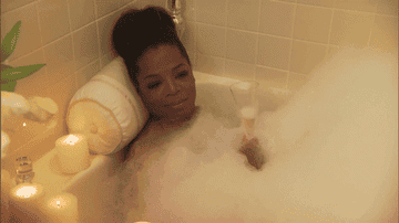Oprah in a bubble bath with a glass of wine on Jimmy Kimmel Live 