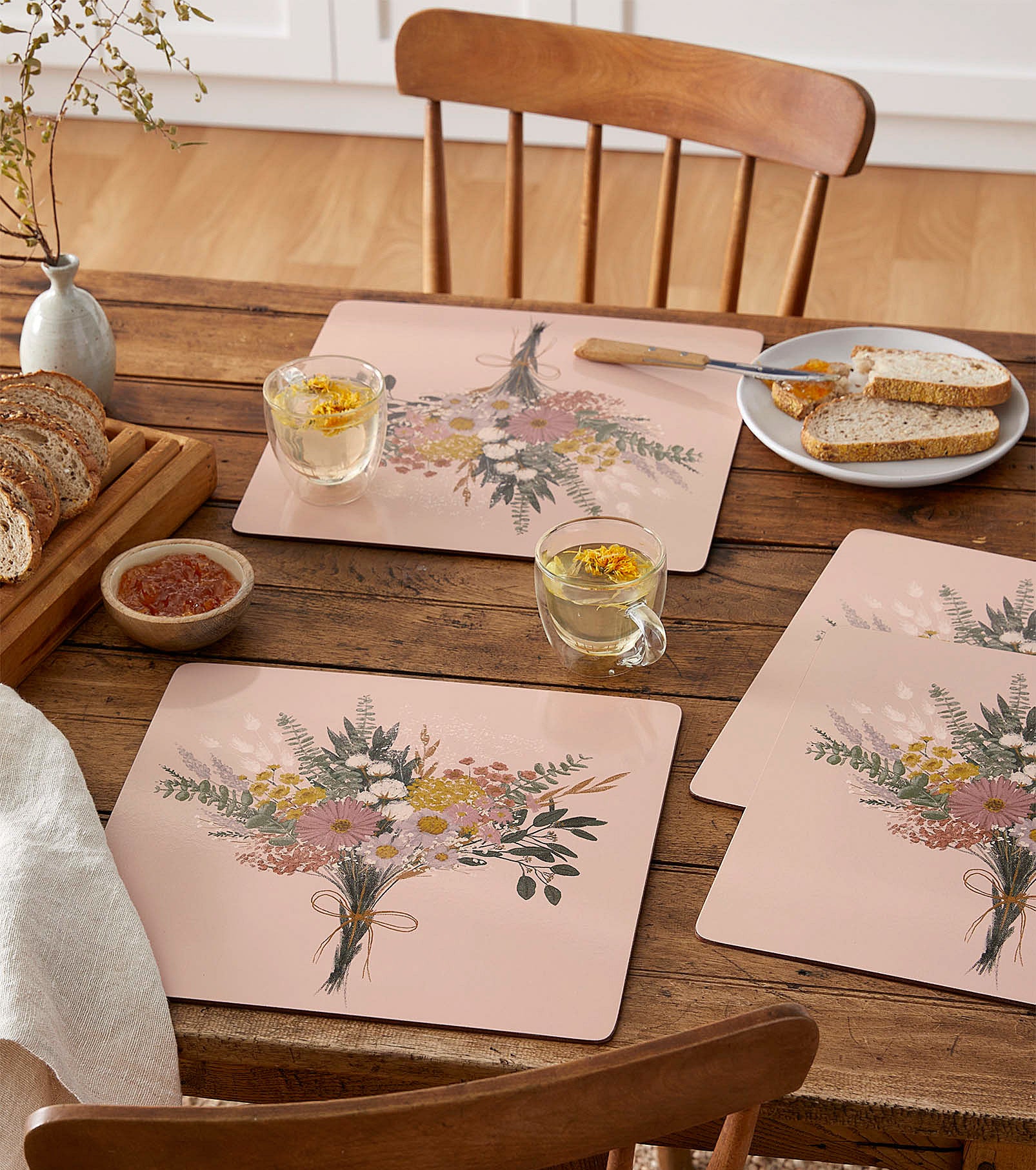 Four placemats with bouquets of flowers designed on each 