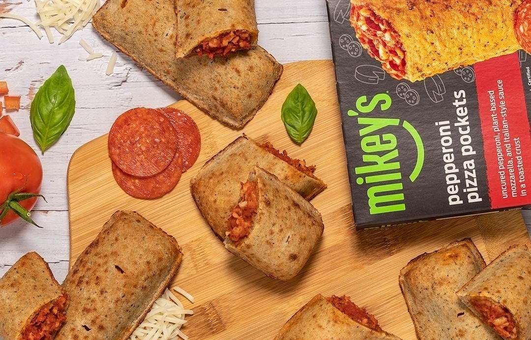 the pizza pocket box surrounded by cooked pizza pockets 