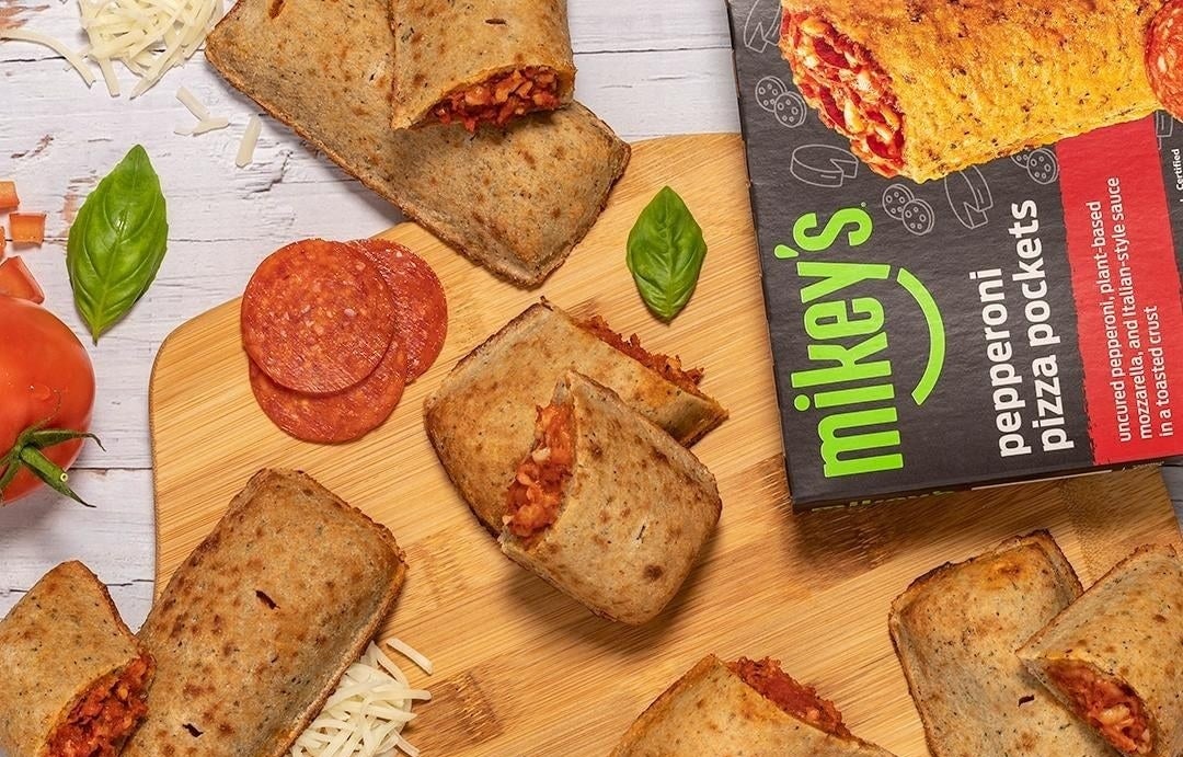 the pizza pocket box surrounded by cooked pizza pockets