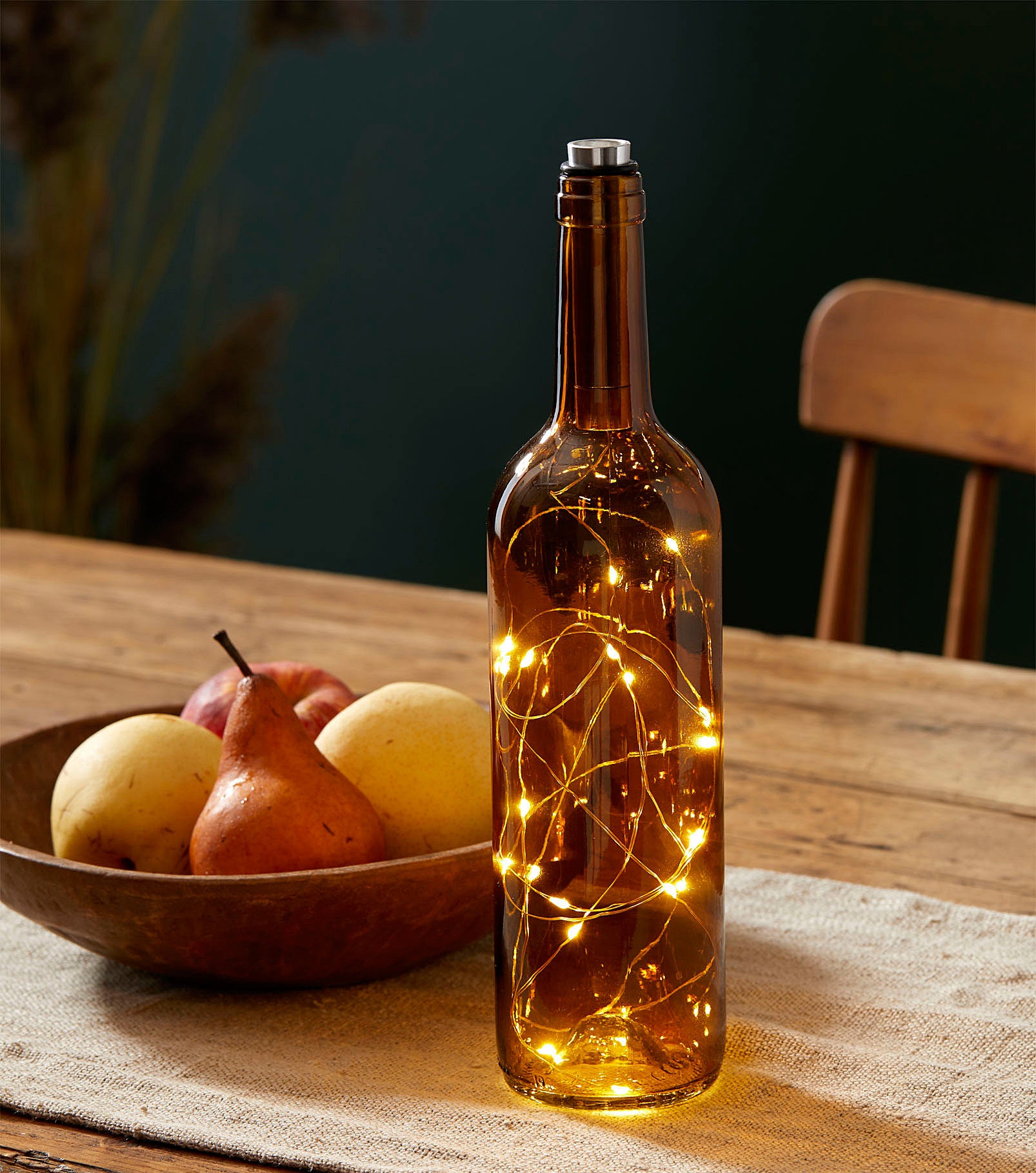 A glowing wine bottle with fairy lights inside 