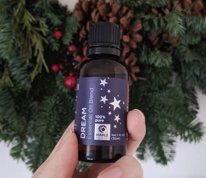 reviewer holding the bottle of Dream essential oil 