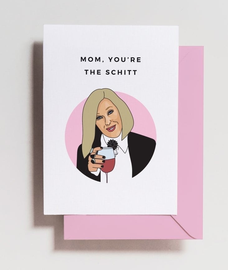 the card with a picture of Moira holding wine and the words &quot;Mom, you&#x27;re the Schitt&quot; and a pink envelope