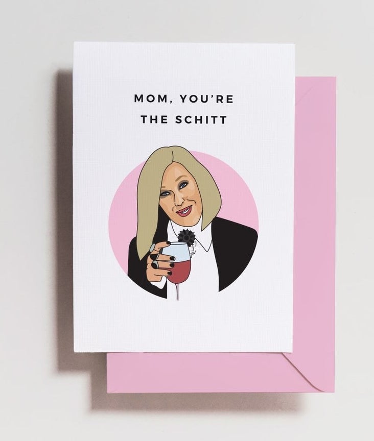the card with a picture of Moira holding wine and the words "Mom, you're the Schitt" and a pink envelope
